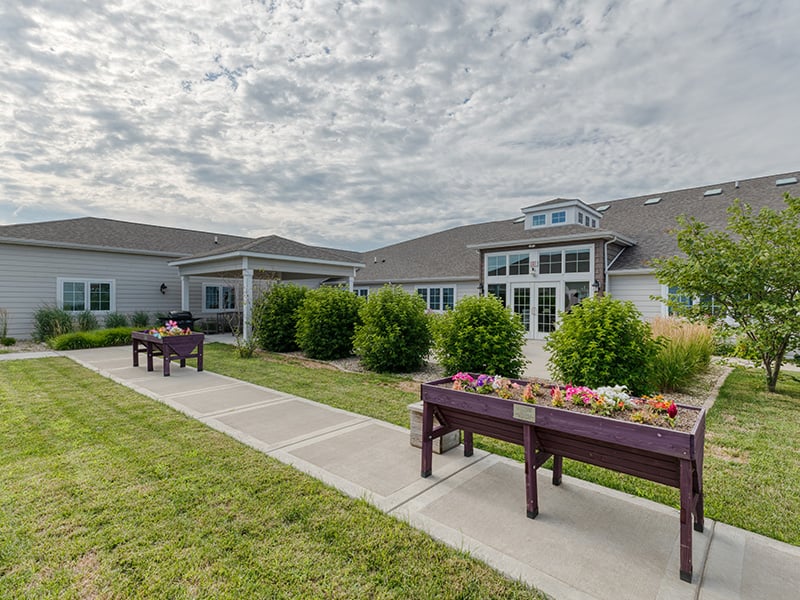 An inviting outdoor garden space at Cedarhurst of Jacksonville, providing areas for relaxation and enjoyment