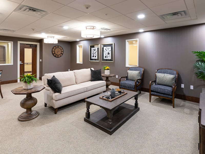 A comfortable common area at Cedarhurst of La Vista, featuring plush seating for residents to relax