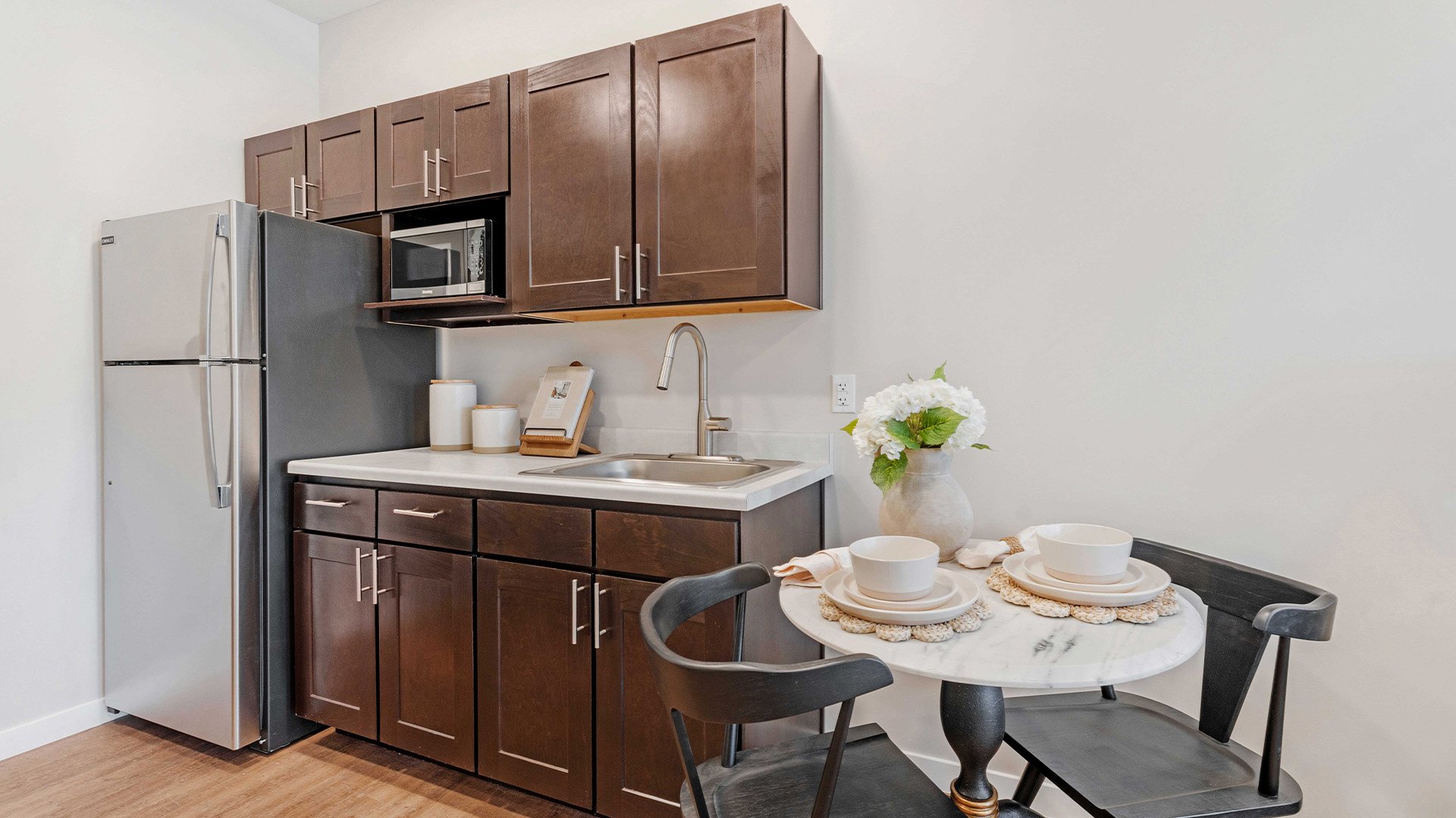 An accessible kitchenette in a senior apartment at Cedarhurst of Lawrence, designed for ease of use and independence.