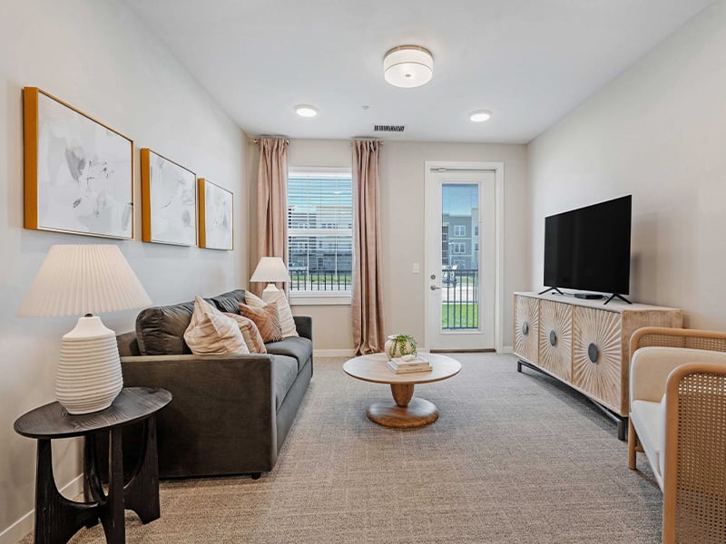A spacious and bright living room inside a senior apartment at Cedarhurst of Lawrence