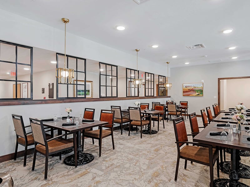 Another elegant dining space at Cedarhurst of Lawrence, offering comfortable, accessible seating for resident meals.