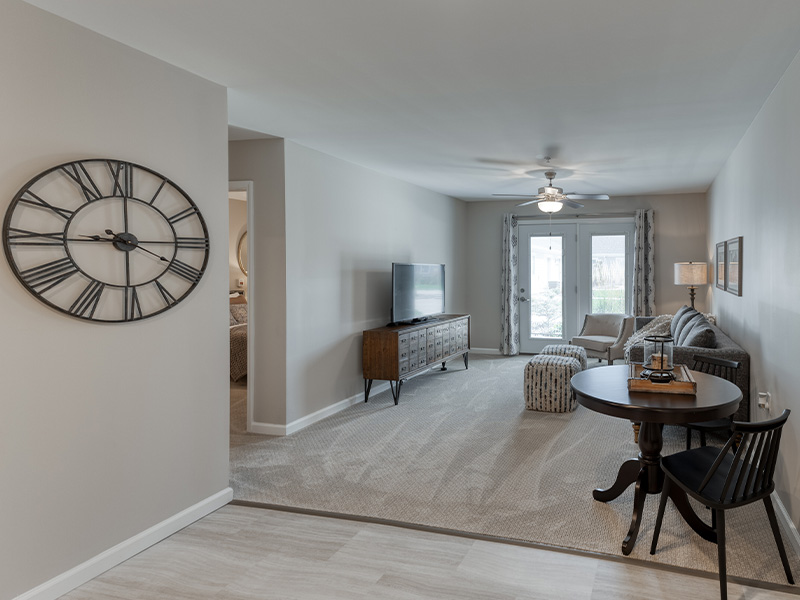 An apartment living room and kitchenette featuring accessible layouts and senior-friendly features at Cedarhurst of Lebanon.