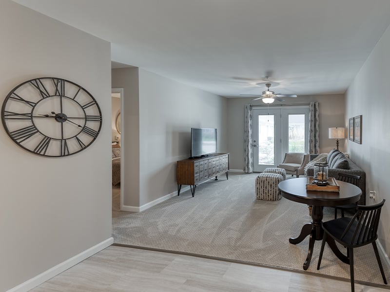 An apartment living room and kitchenette featuring accessible layouts and senior-friendly features at Cedarhurst of Lebanon.