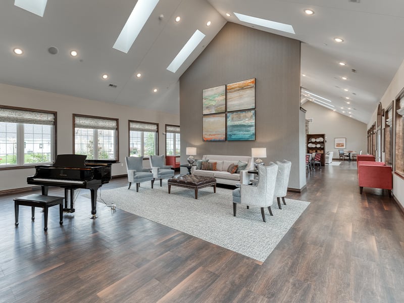 Cedarhurst of Lebanon residential common area with a comfortable seating and a piano.