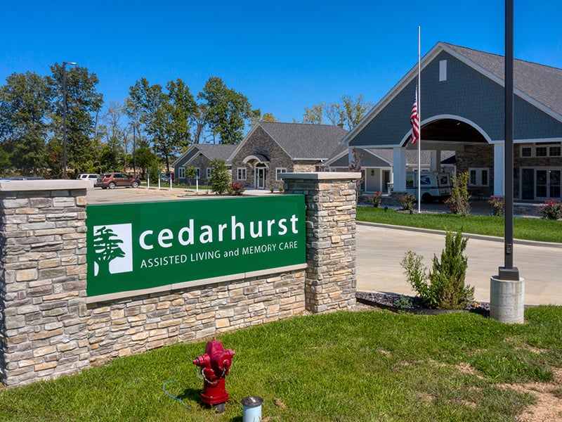 An inviting view of the Cedarhurst of Lebanon senior living community from the outside, complete with the main building and its distinctive sign.