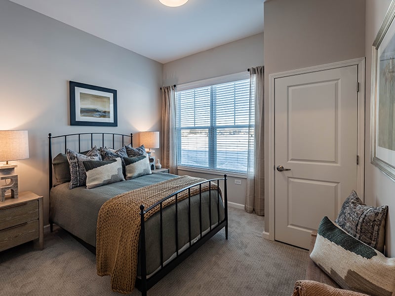 Bedroom of a senior apartment at Cedarhurst of McHenry, designed for resident comfort and personalization.