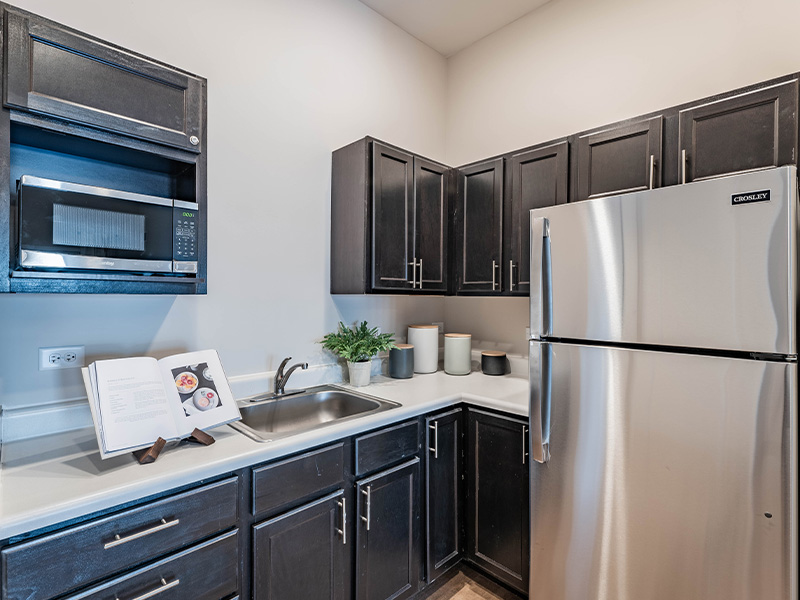 An accessible kitchenette in a senior apartment at Cedarhurst of McHenry, designed for ease of use and independence.