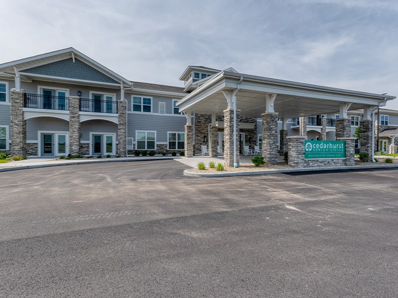 An inviting view of the Cedarhurst of McHenry senior living community from the outside, complete with the main building and its distinctive sign.