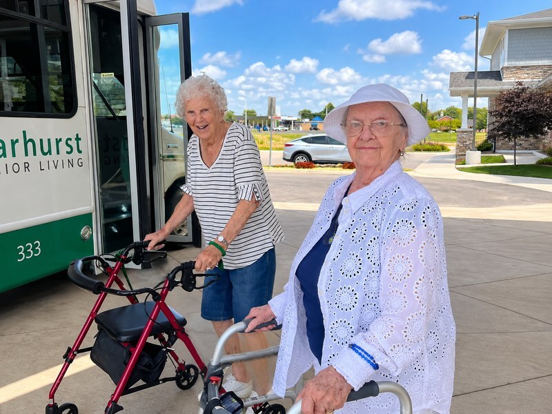 Senior living community residents getting ready to board the community bus for an outing.