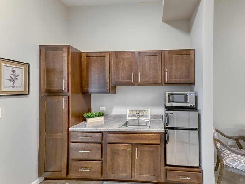 An accessible kitchenette in a senior apartment at Cedarhurst of Naperville, designed for ease of use and independence.