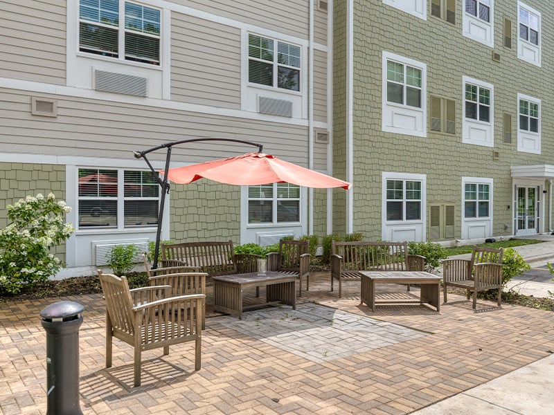Outdoor space at Cedarhurst of Naperville with paved walking paths and seating.