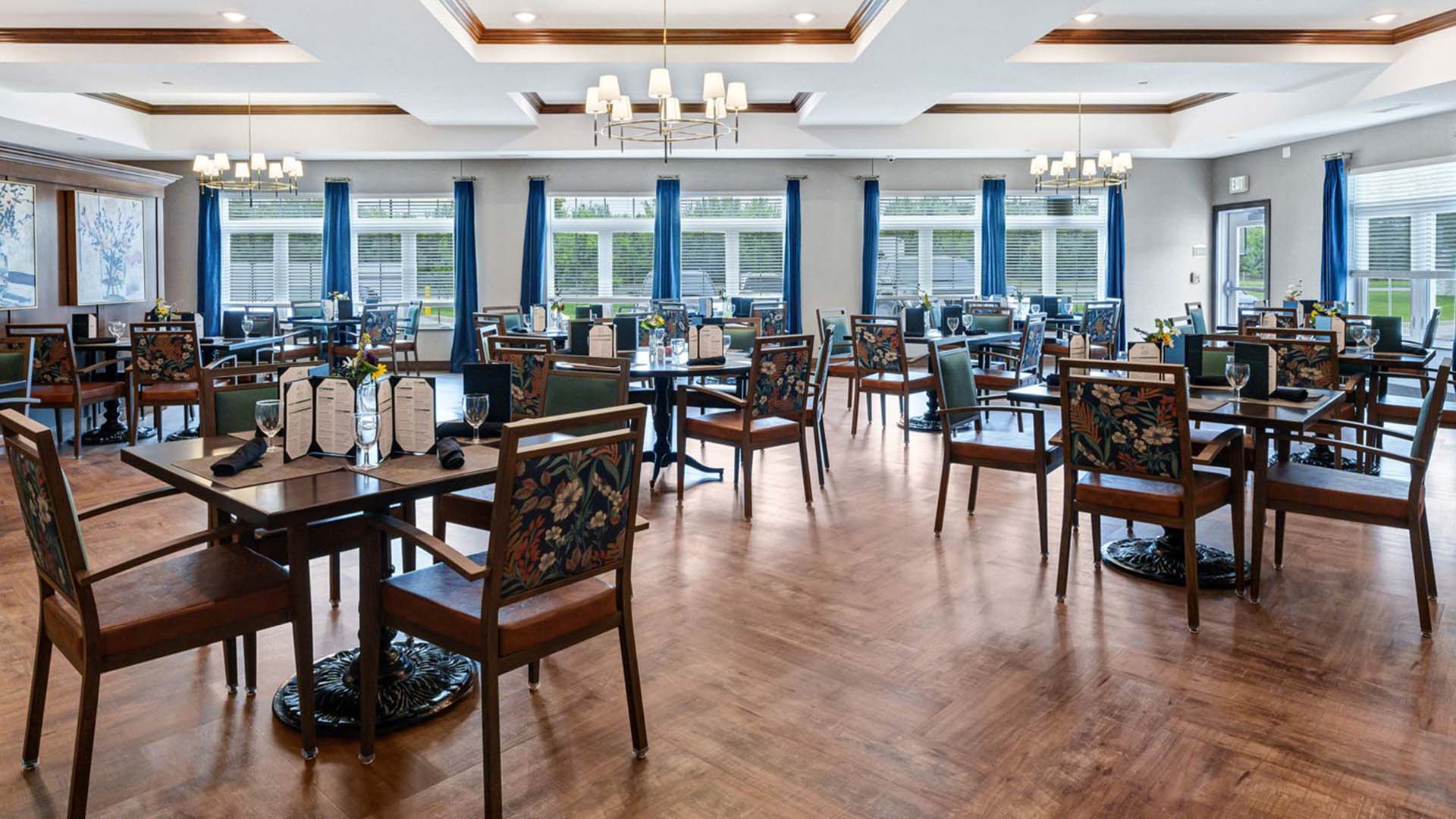 A spacious and bright dining room at Cedarhurst of Newburgh, offering comfortable seating for meals.