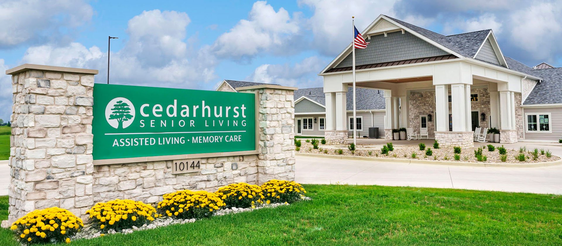 An inviting view of the Cedarhurst of Newburgh senior living community from the outside, complete with the main building and its distinctive sign.