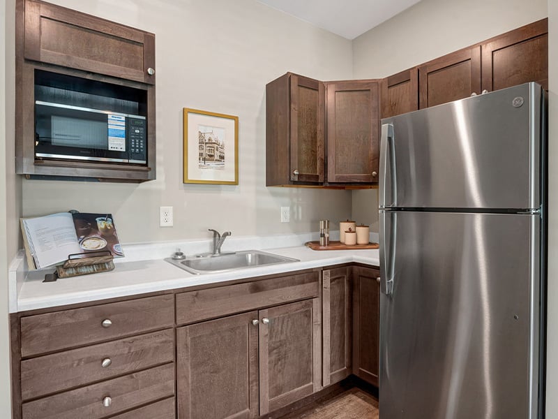 An accessible kitchenette in a senior apartment at Cedarhurst of Newburgh, designed for ease of use and independence.