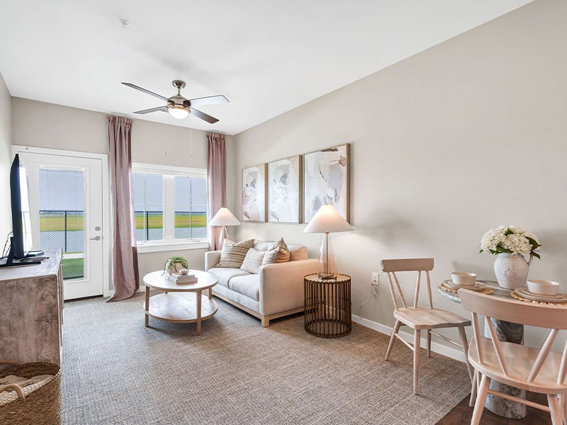 Senior-friendly apartment living room at Cedarhurst of Newburgh, offering comfortable and accessible design for residents.