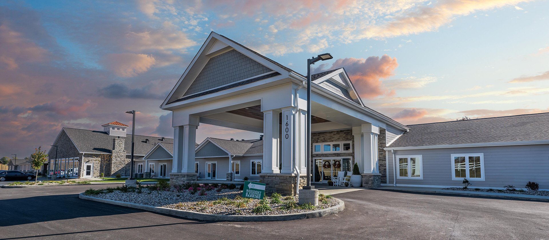 An inviting view of the Cedarhurst of Nicholasville senior living community from the outside, complete with the main building and its distinctive sign.