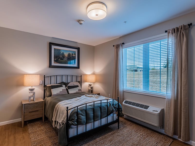 Cedarhurst of Nicholasville: A cozy and well-appointed senior apartment bedroom for residents.