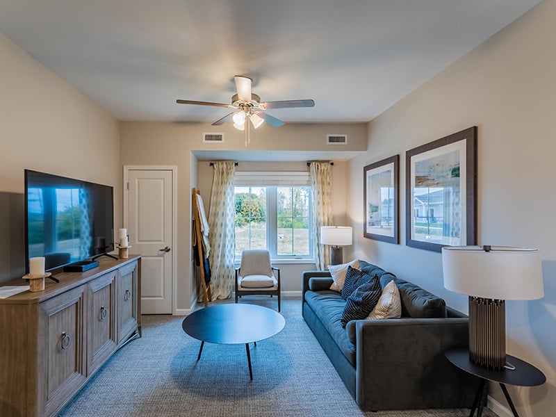 Senior-friendly apartment living room at Cedarhurst of Nicholasville, offering comfortable and accessible design for residents.