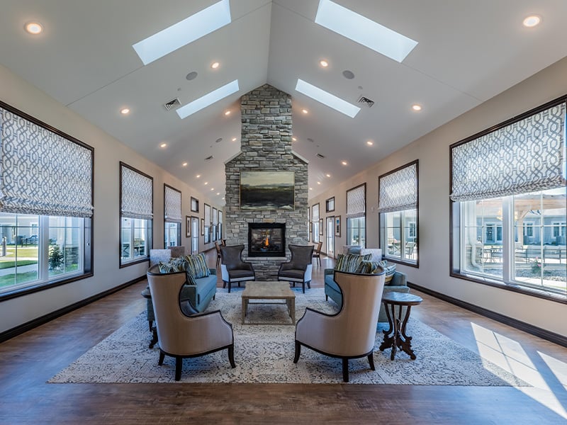 Cedarhurst of Nicholasville's spacious common area, complete with comfortable seating and a cozy fireplace