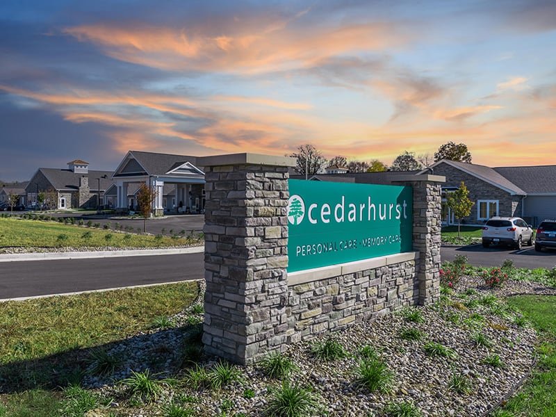An inviting view of the Cedarhurst of Nicholasville senior living community from the outside, complete with the main building and its distinctive sign.