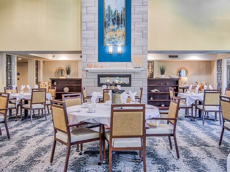 A spacious and bright dining room at Cedarhurst of O'Fallon, offering comfortable seating for meals