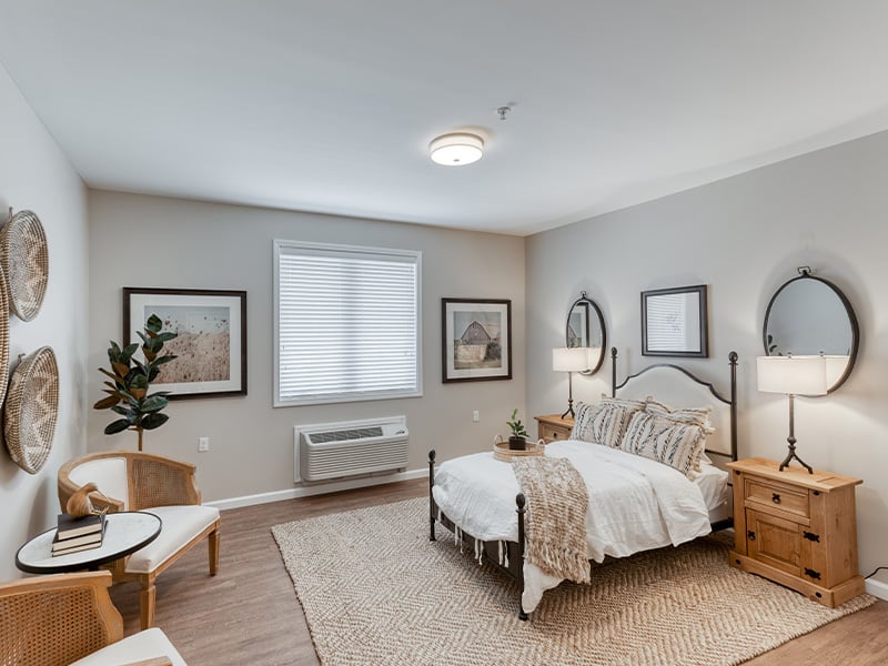 Cedarhurst of Owensboro: A cozy and well-appointed senior apartment bedroom for residents.