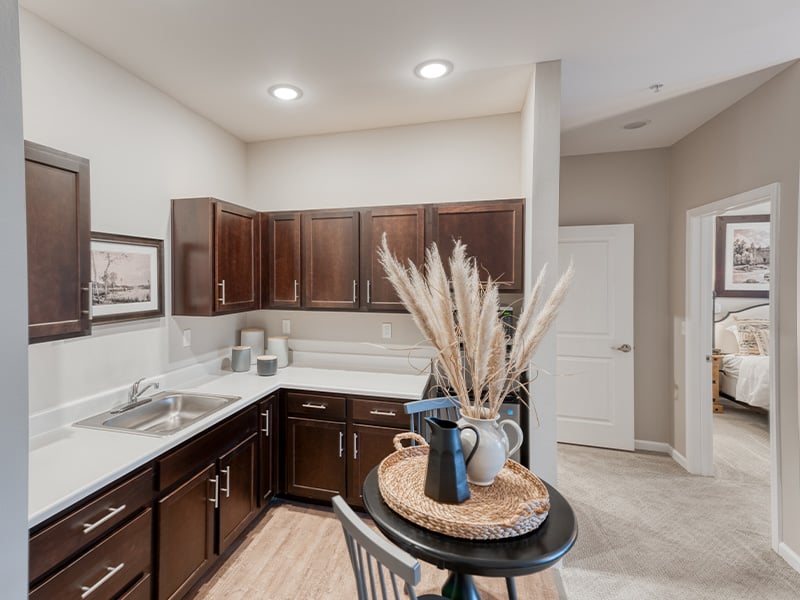 An accessible kitchenette in a senior apartment at Cedarhurst of Owensboro, designed for ease of use and independence.