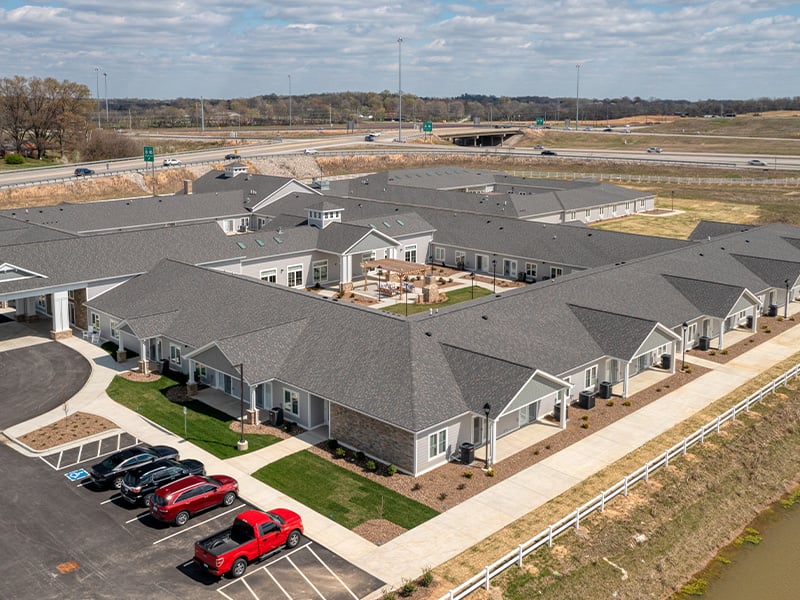 Aerial view of the entire Cedarhurst of Owensboro senior living community building and grounds.