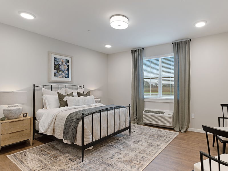 Bedroom of a senior apartment at Cedarhurst of Salina, designed for resident comfort and personalization