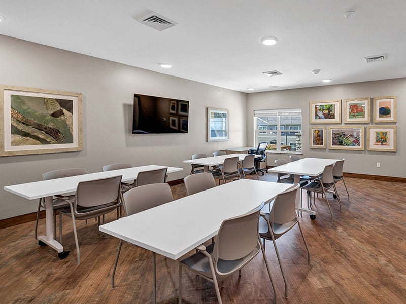 A bright and welcoming activity room at Cedarhurst of Shawnee, offering various opportunities for recreation
