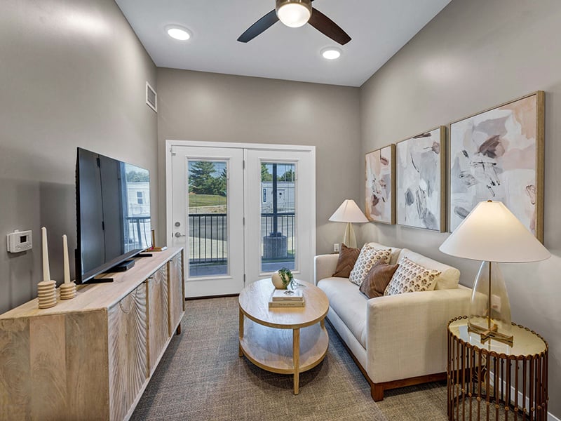 Senior-friendly apartment living room at Cedarhurst of Shawnee, offering comfortable and accessible design for residents