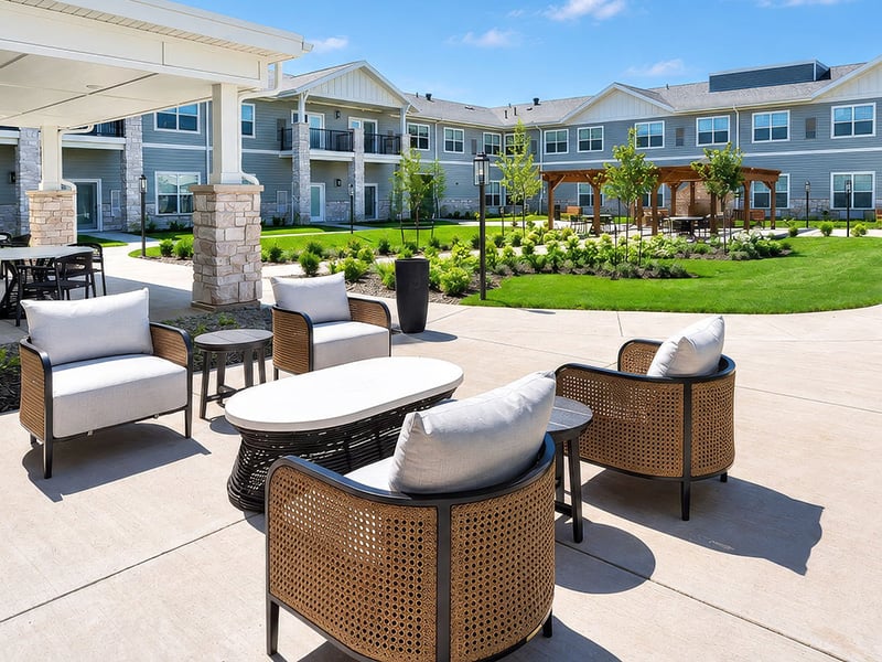 An inviting outdoor space with paved walking paths and a wooden pergola at Cedarhurst of Shawnee senior living community