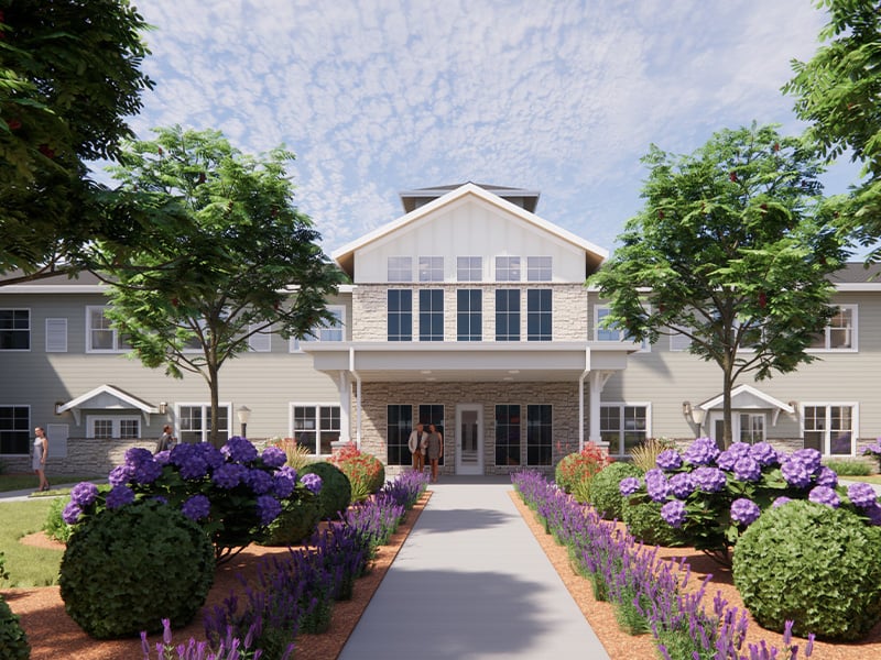 Outdoor green space at Cedarhurst of Shawnee with paved walking paths and garden beds