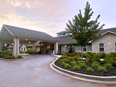 An inviting view of the Cedarhurst of Spartanburg senior living community from the outside, complete with the main building and its distinctive sign.
