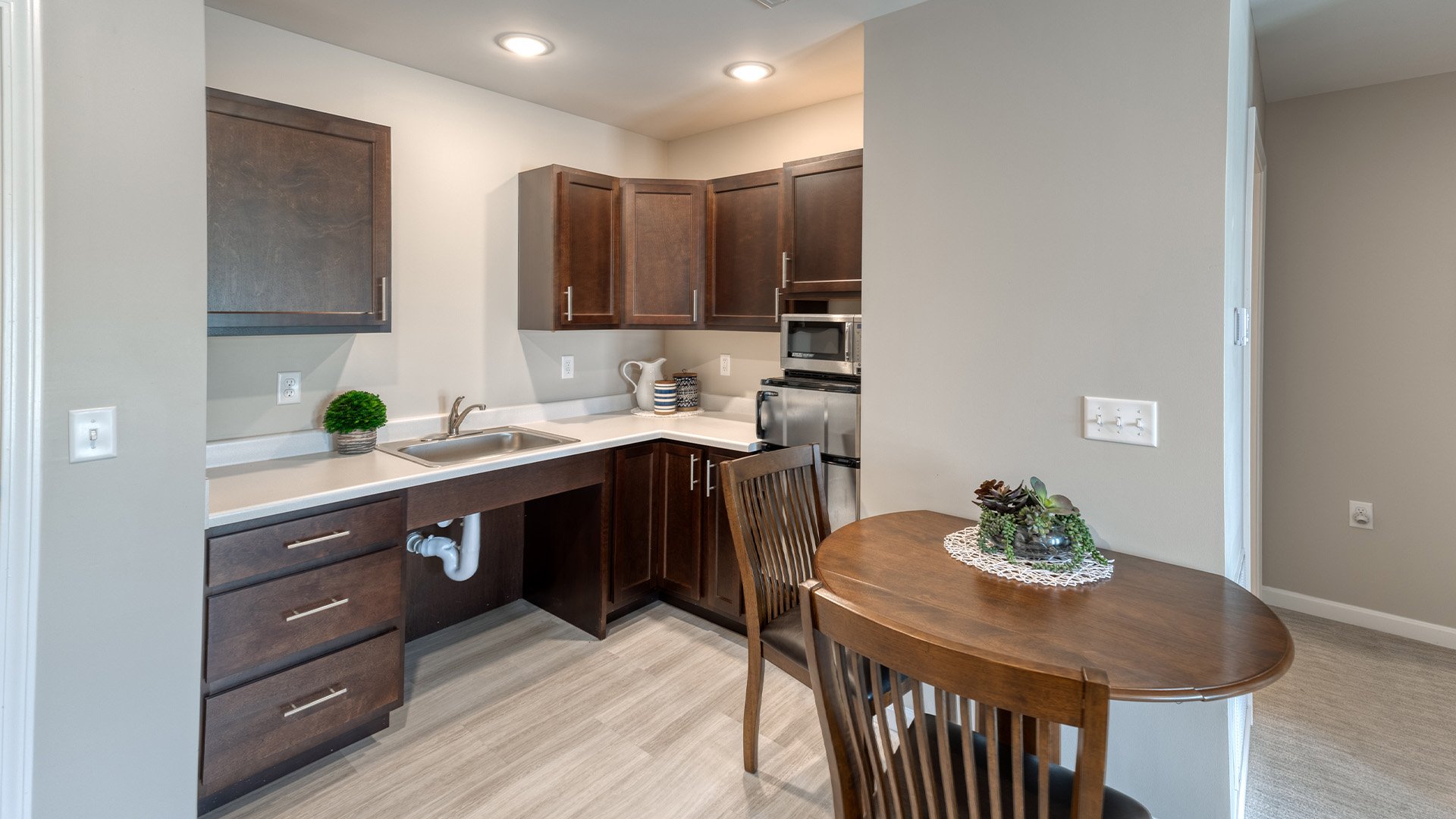 An accessible kitchenette in a senior apartment at Cedarhurst of Springfield, IL, designed for ease of use and independence