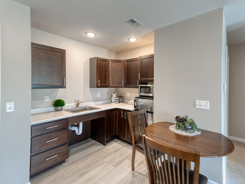 An accessible kitchenette in a senior apartment at Cedarhurst of Springfield, IL, designed for ease of use and independence