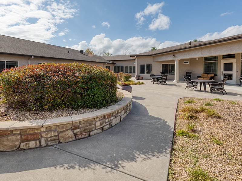 An inviting outdoor covered patio with a at Cedarhurst of Springfield, MO senior living community
