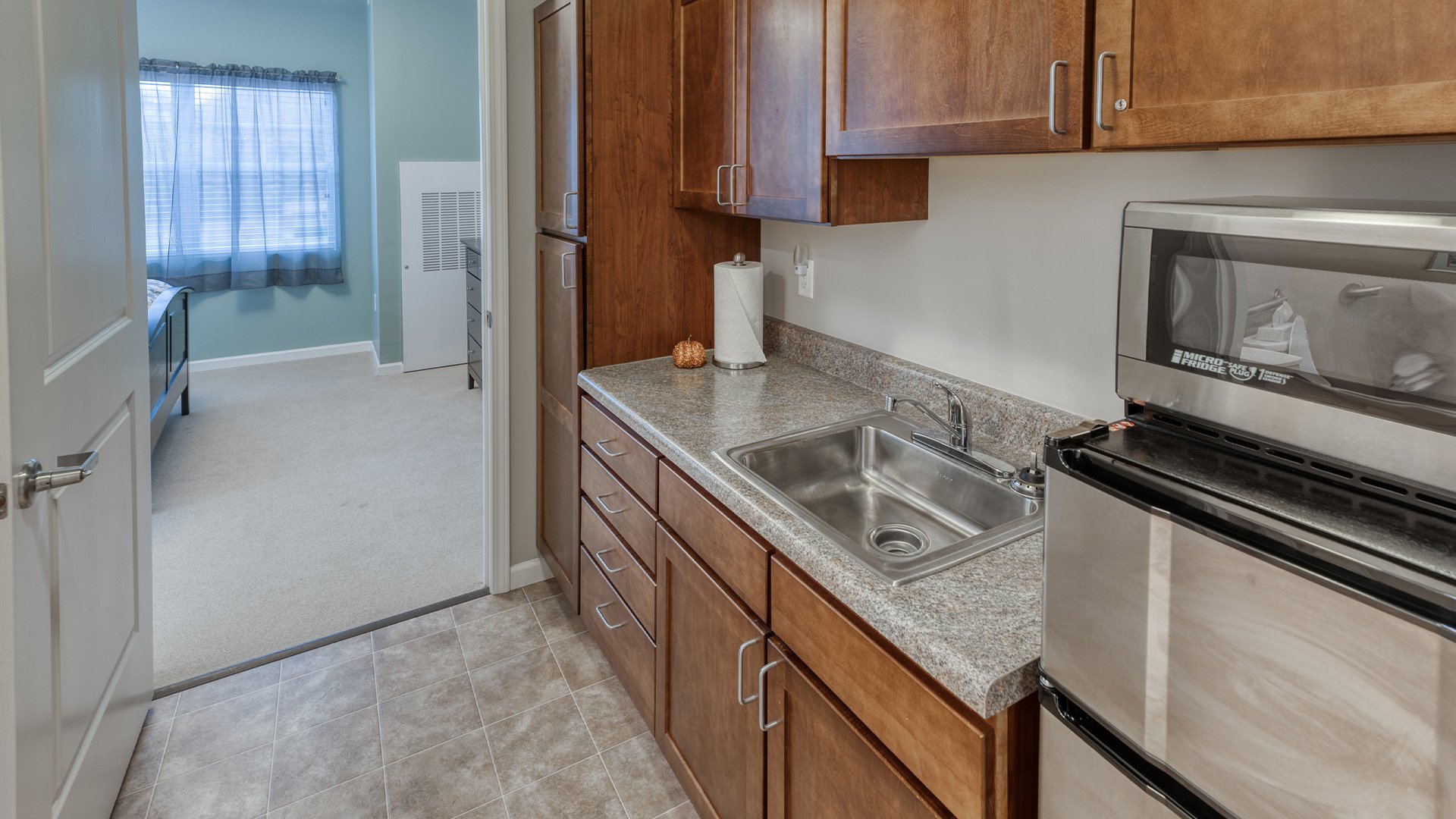 An accessible kitchenette in a senior apartment at Cedarhurst of St. Charles, designed for ease of use and independence
