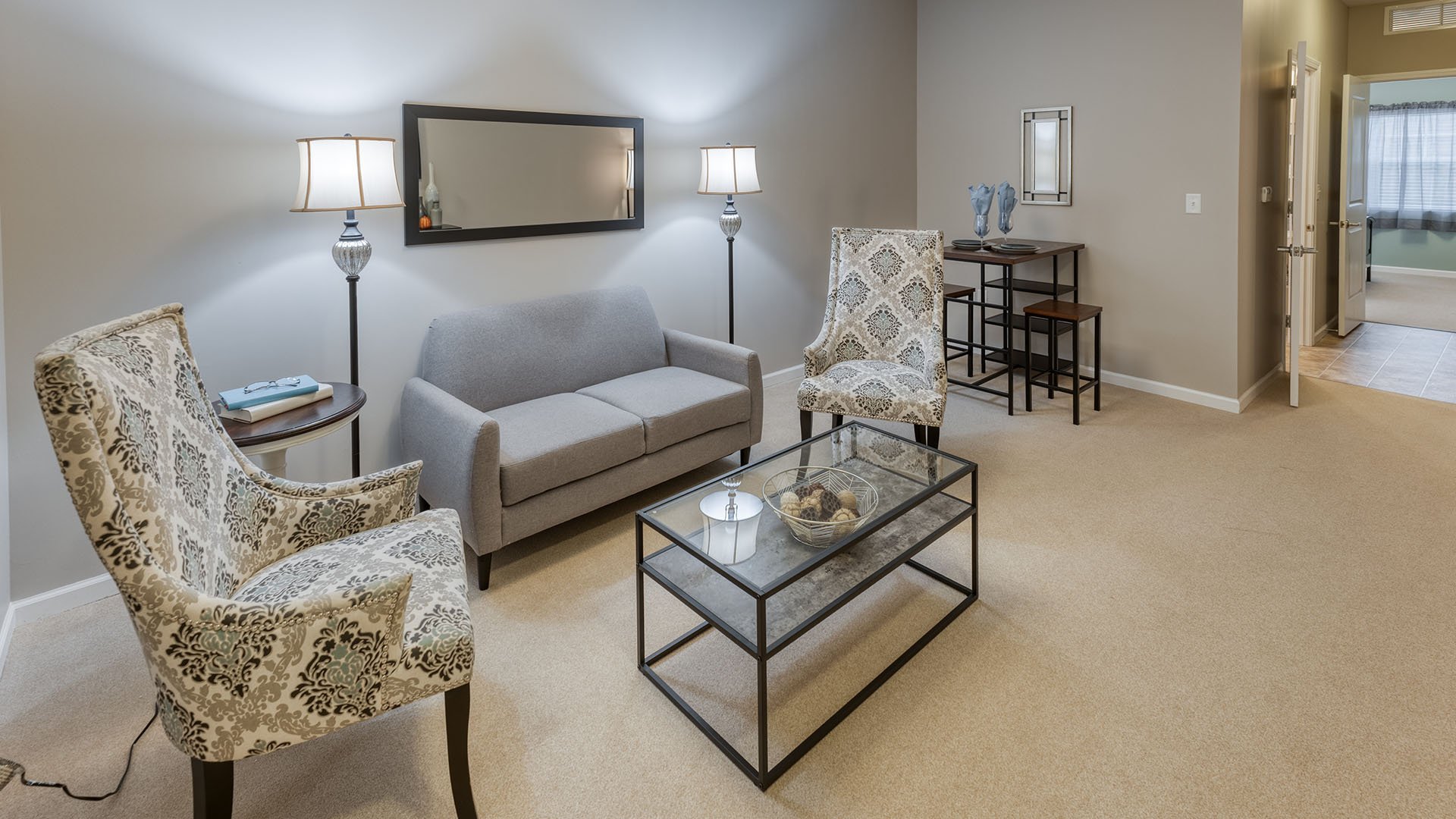 Senior-friendly apartment living room at Cedarhurst of St. Charles, offering comfortable and accessible design for residents