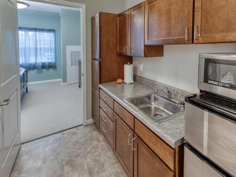 An accessible kitchenette in a senior apartment at Cedarhurst of St. Charles, designed for ease of use and independence