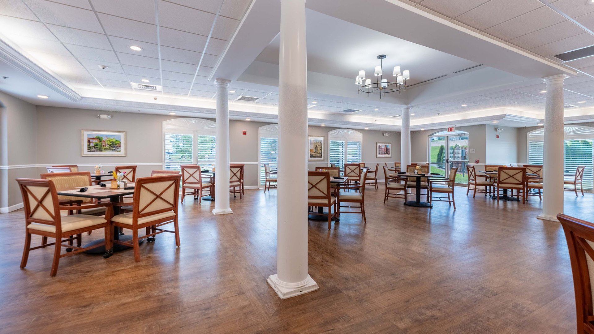 A spacious and bright dining room at Cedarhurst of Tesson Heights, offering comfortable seating for meals