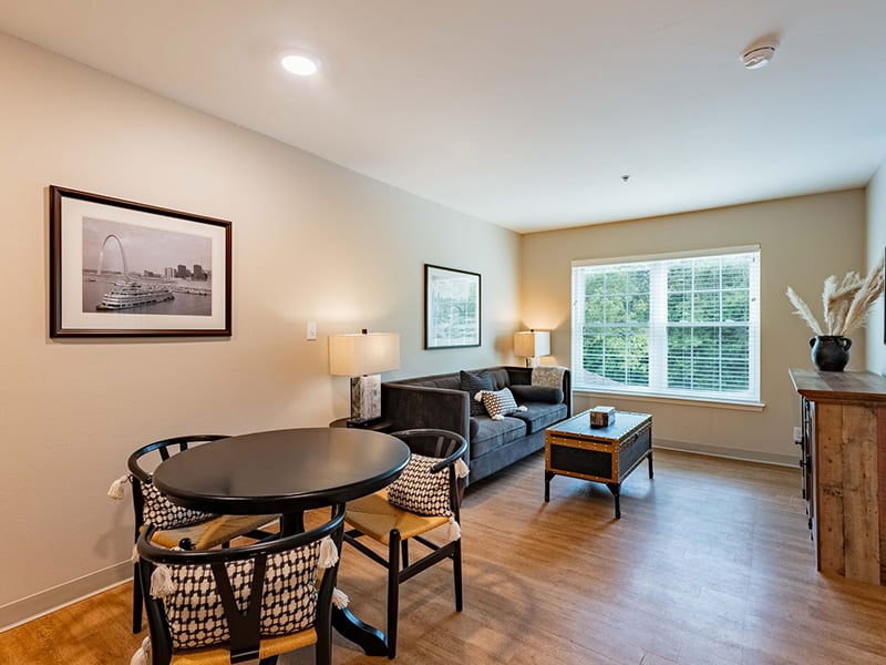 Senior-friendly apartment living room at Cedarhurst of Tesson Heights, offering comfortable and accessible design for residents