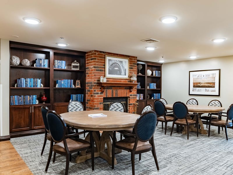 A welcoming, senior-friendly library at Cedarhurst of Tesson Heights with accessible resources for reading and relaxation