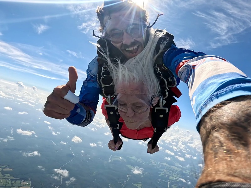 Cedarhurst of Tesson Heights assisted living resident tandem skydiving above the clouds as part of the Dream Come True program