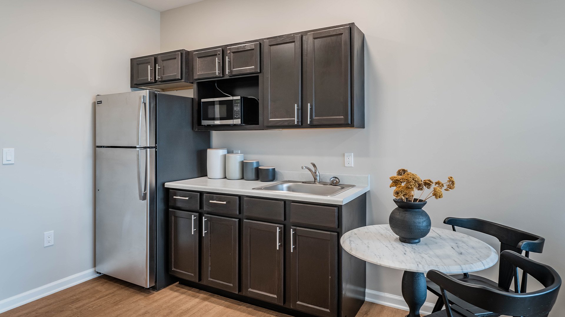 An accessible kitchenette in a senior apartment at Cedarhurst of Topeka, designed for ease of use and independence