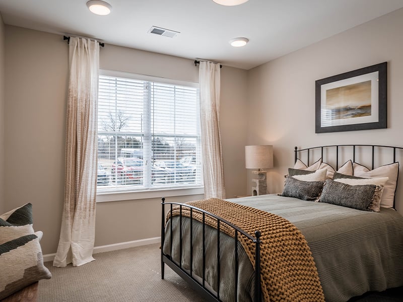 Cedarhurst of Topeka: A cozy and well-appointed senior apartment bedroom for residents