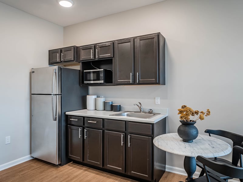 An accessible kitchenette in a senior apartment at Cedarhurst of Topeka, designed for ease of use and independence