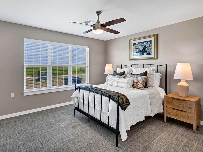 Bright and spacious bedroom in Cedarhurst of Topeka's Independent Living at Cedarhurst Cottages, featuring walk-in closet