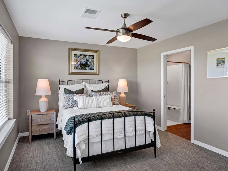 View from the bedroom toward an attached bathroom in Cedarhurst of Topeka's Independent Living at Cedarhurst Cottages