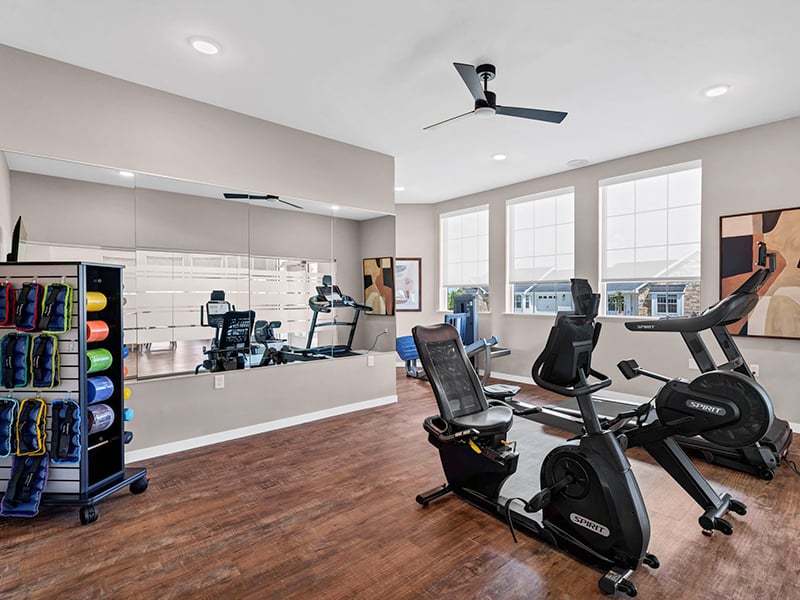 Clubhouse fitness center with treadmills and recumbent bikes at Cedarhurst of Topeka's Independent Living at Cedarhurst Cottages